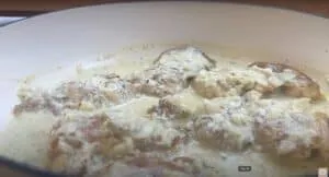 Creamy garlic chicken in a skillet, topped with herbs and cheese for a delicious homemade meal.